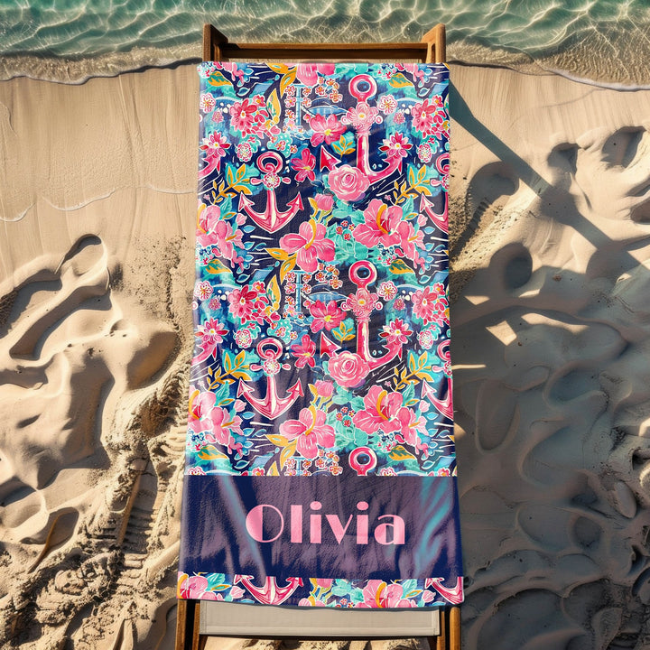 a beach towel with an anchor and flowers on it