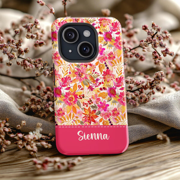 a pink phone case with a floral pattern on it