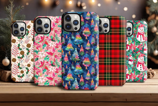 a group of four phone cases sitting on top of a wooden table