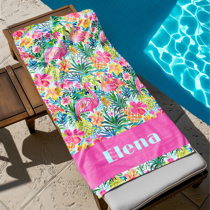 a personalized beach towel sitting next to a pool