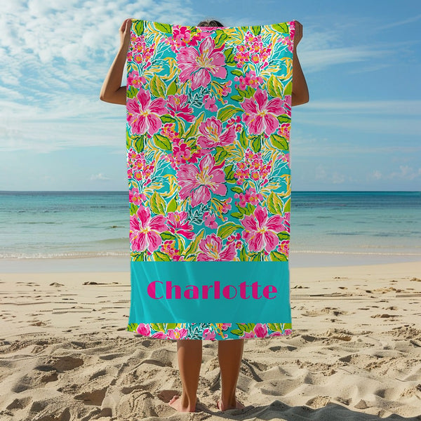 a person standing on a beach holding a towel